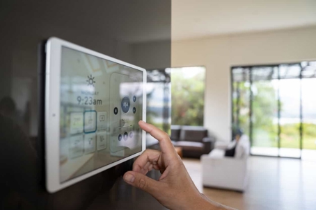 hand using a smart home control tablet